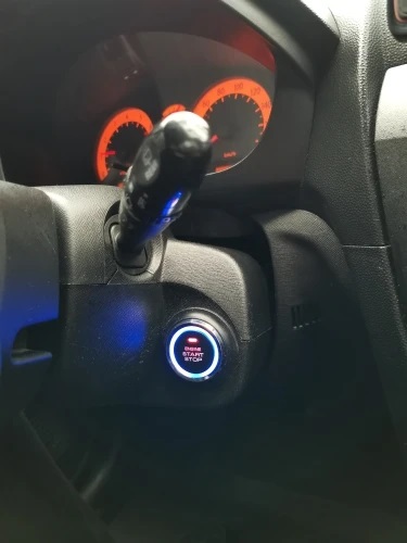 Aftermarket engine start stop button installed in an older vehicle